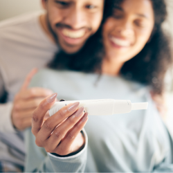 a man and a woman are looking at a pregnancy test .