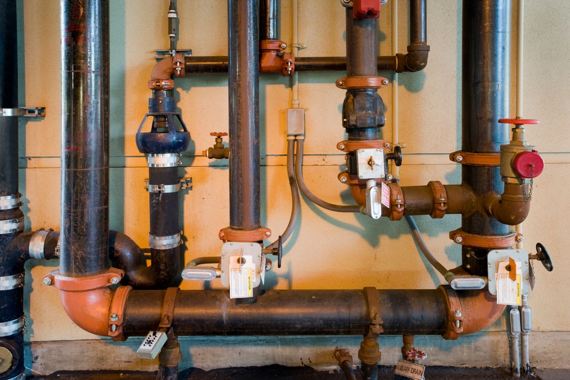 A bunch of pipes are lined up on a wall