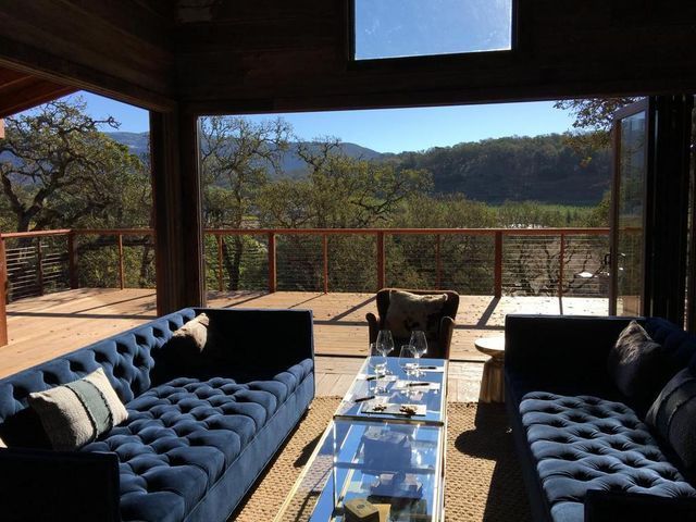 A living room with two blue couches and a glass table