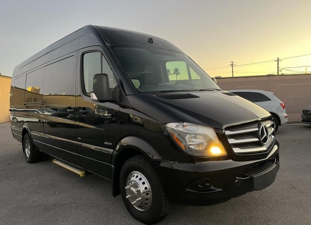 A black mercedes benz sprinter van is parked in a parking lot.