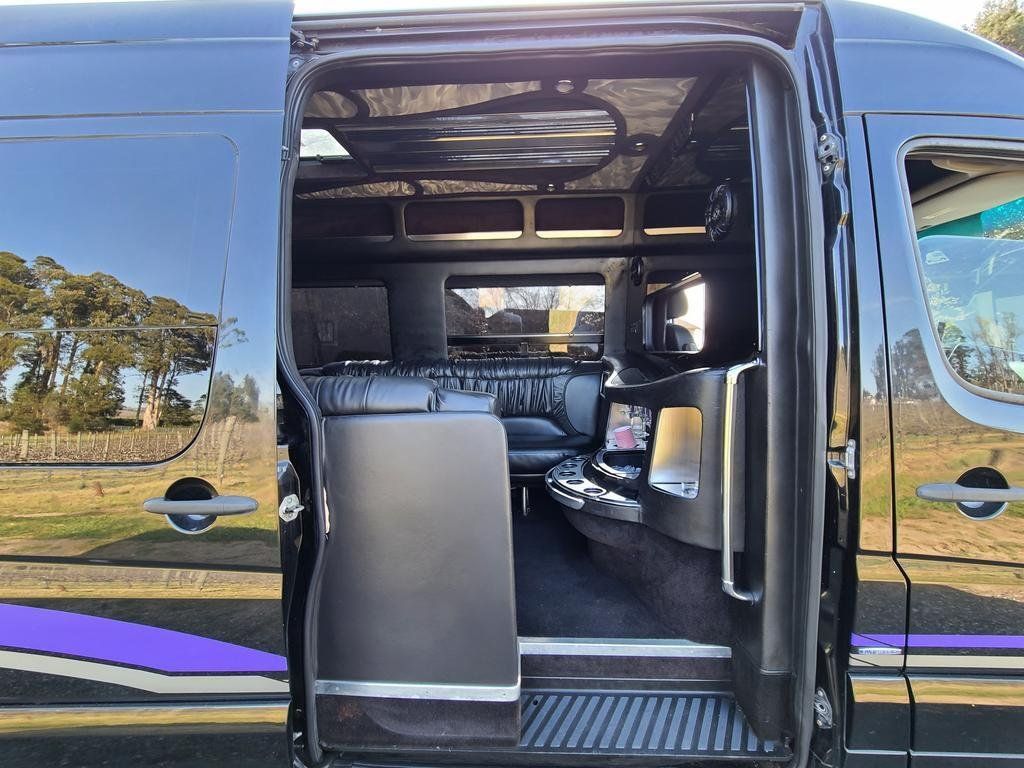 The inside of a black van with the door open.