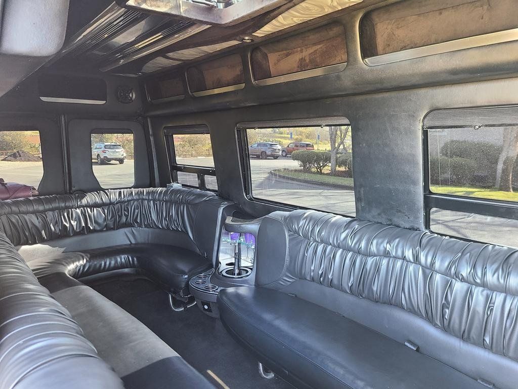 The inside of a limousine with a lot of seats and a lot of windows.