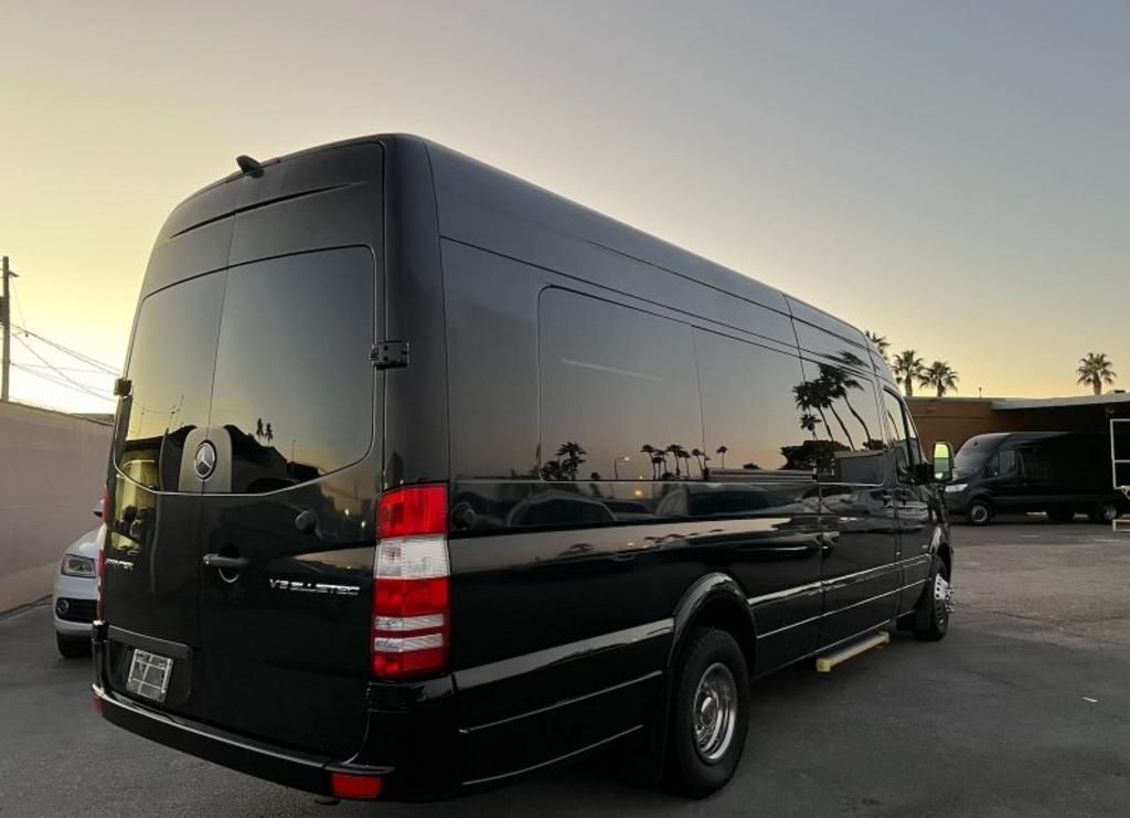 A black van is parked in a parking lot.