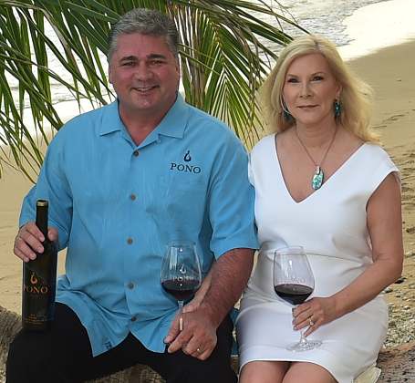 Man and woman holding a glass of wine.