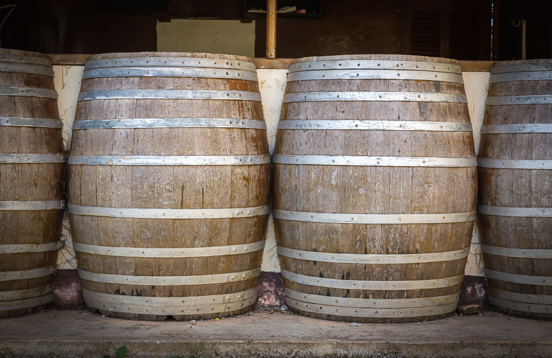 A row of wooden barrels are stacked on top of each other.