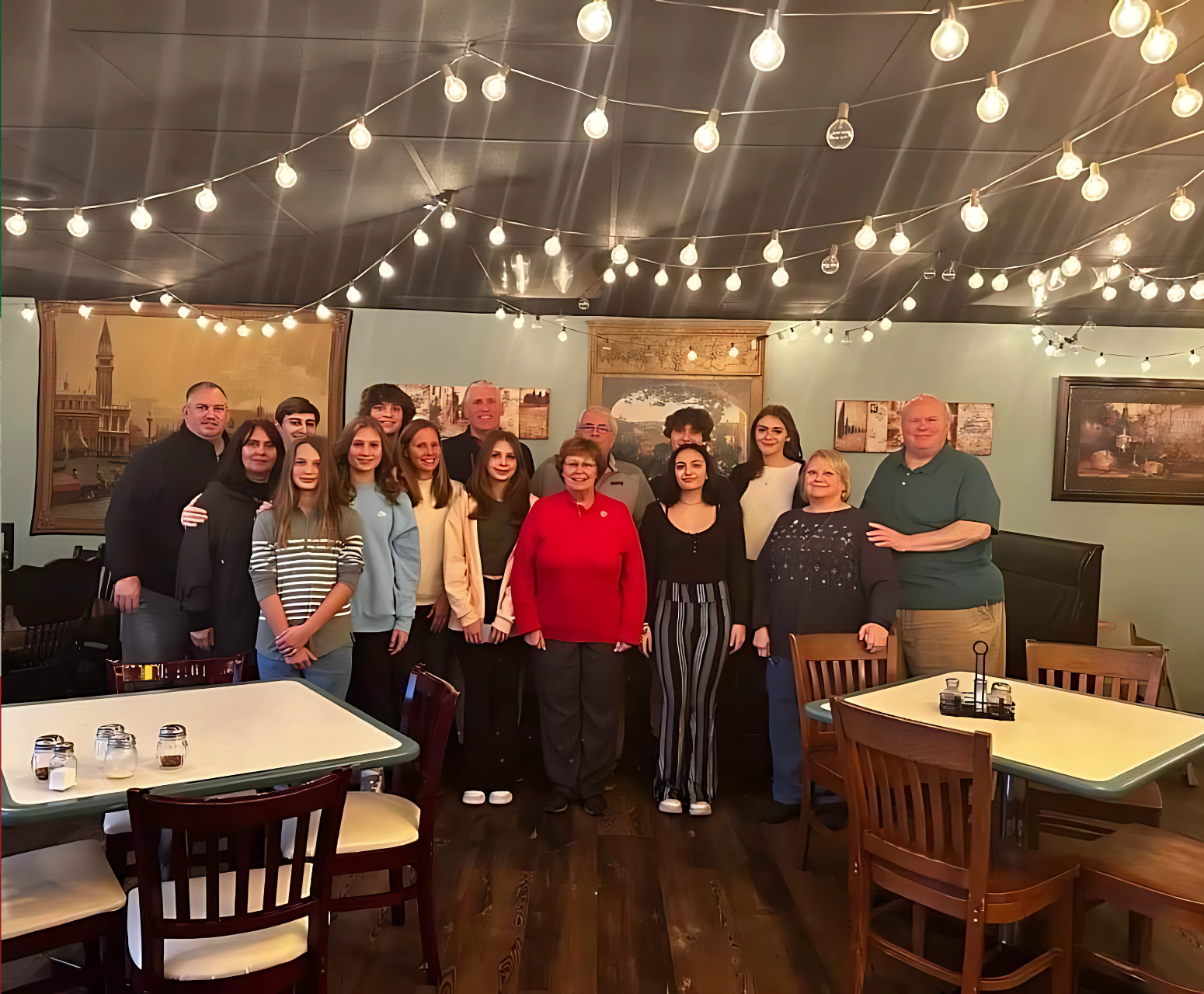 A group of people are posing for a picture in a restaurant