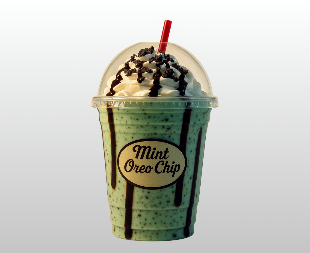 A mint oreo chip milkshake with whipped cream and crushed oreos