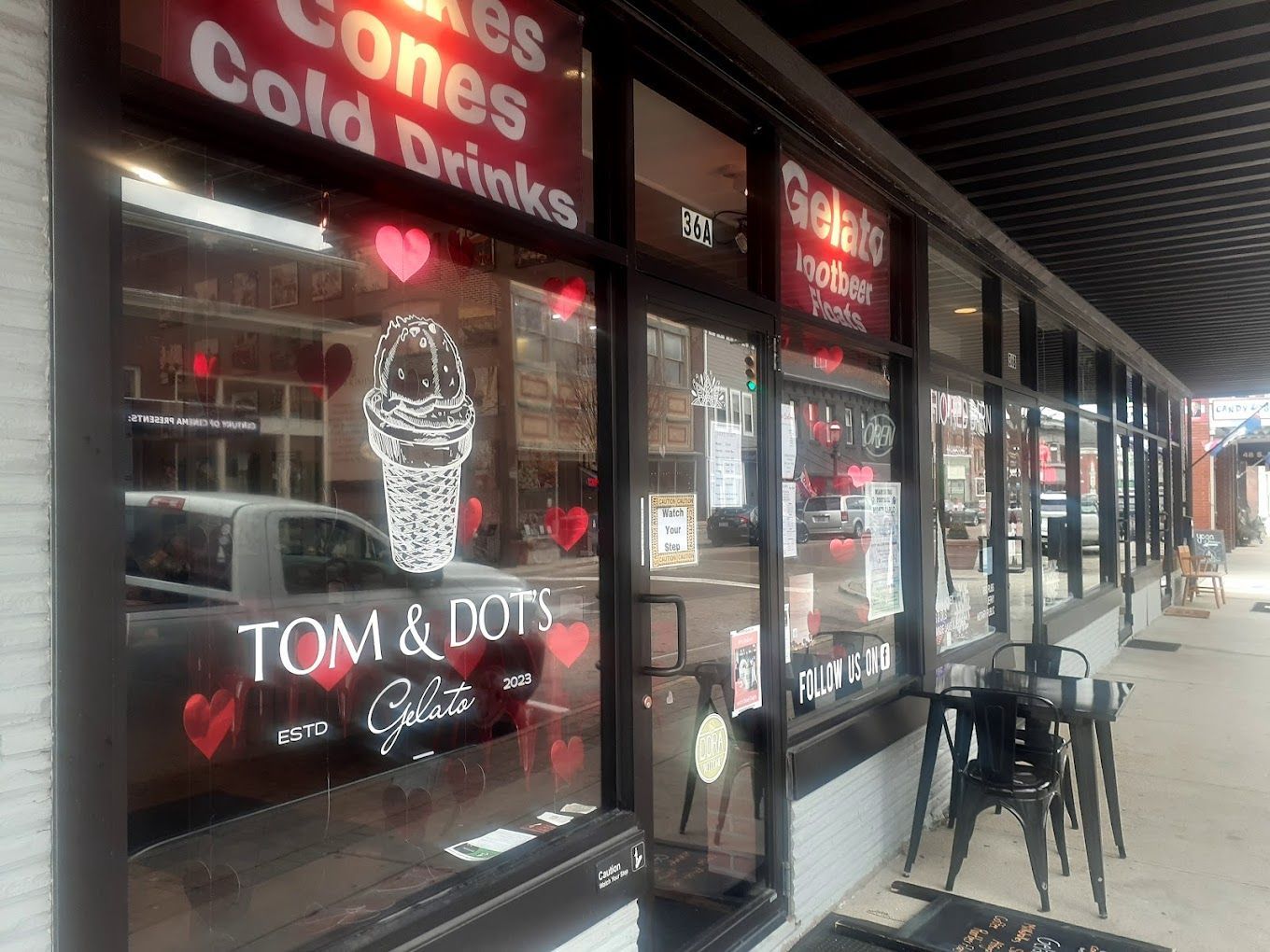 A store front with a sign that says cones cold drinks