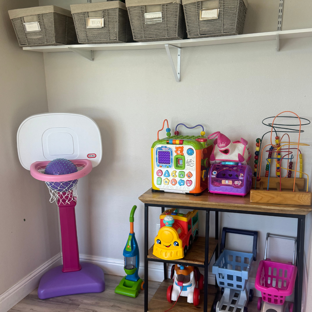 A room with a basketball hoop and toys on a table