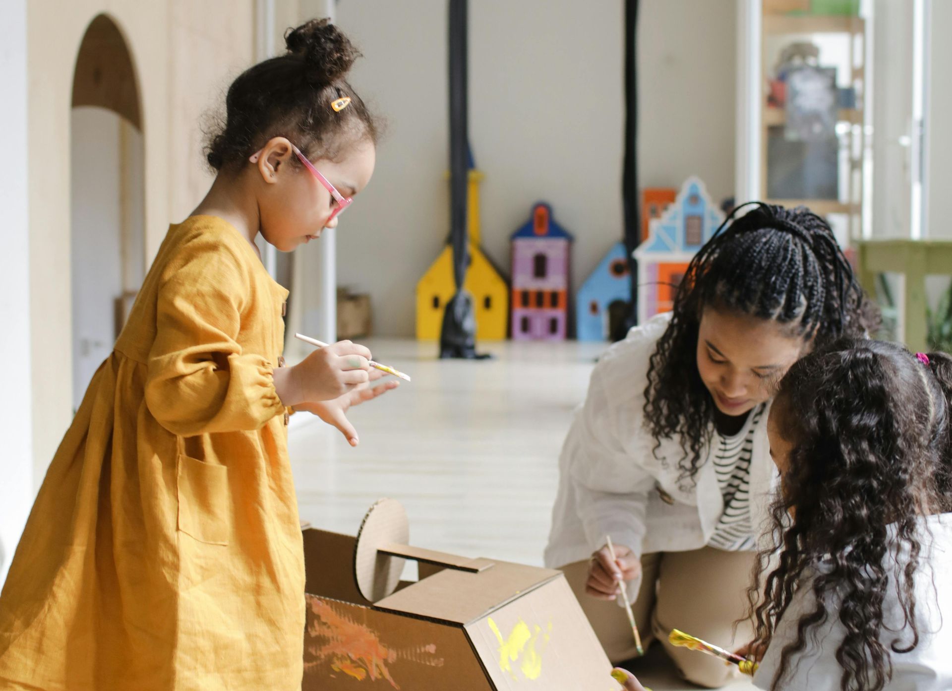 A group of children are playing with a cardboard box.