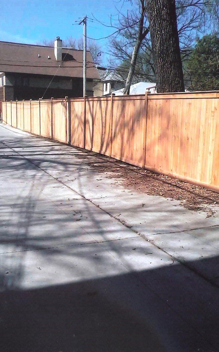 A home with a new fence put up by a fence contractor serving Chicago, IL
