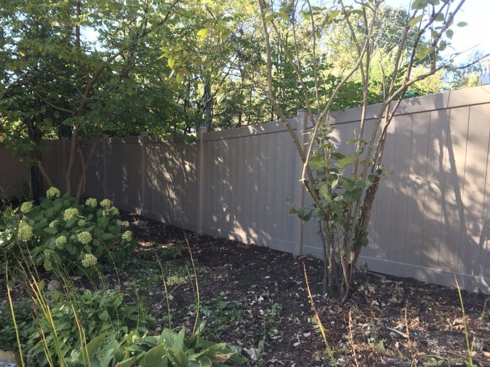 New Wooden Fence with Trees Around — Maywood, IL — Anaya and Sons Fence Company