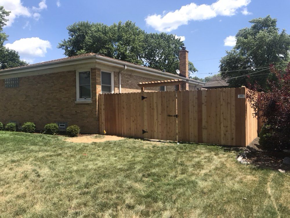 Green Lawn and House Fence — Maywood, IL — Anaya and Sons Fence Company