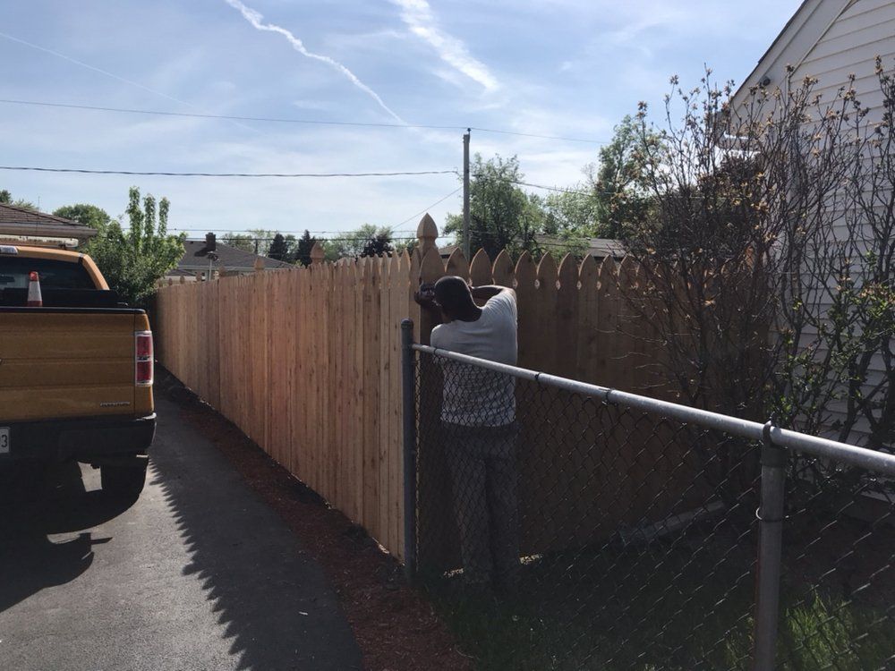 Man Fixing Fence — Maywood, IL — Anaya and Sons Fence Company