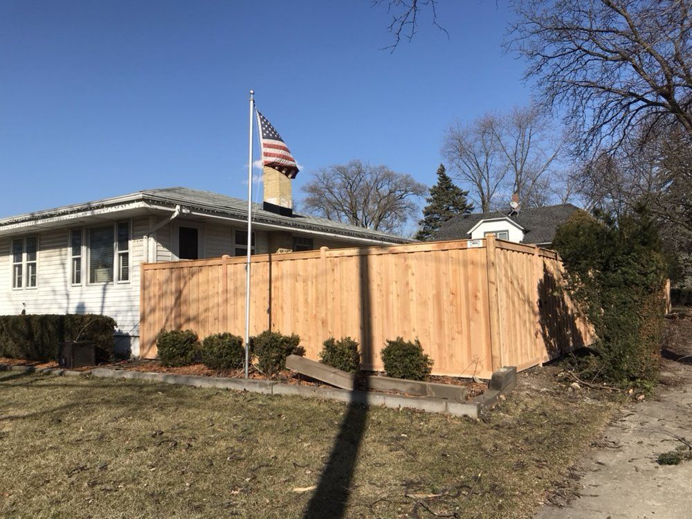 Wooden Fence with Flag — Maywood, IL — Anaya and Sons Fence Company