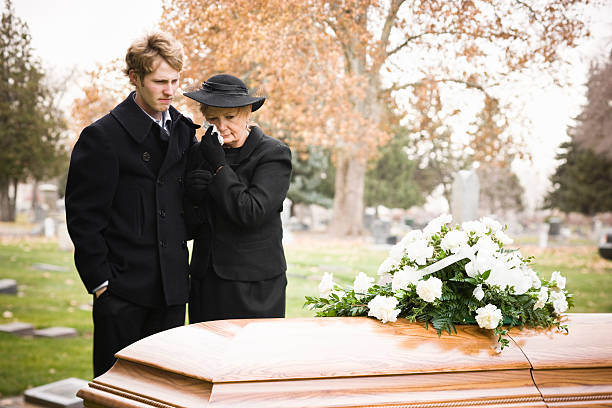 A mother and son attending the funeral of their family member
