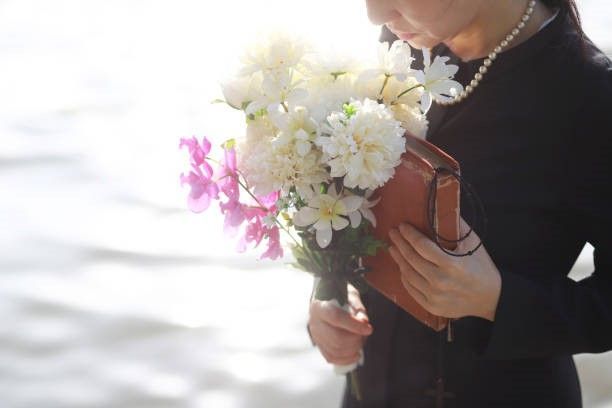 lady holding a book and flower