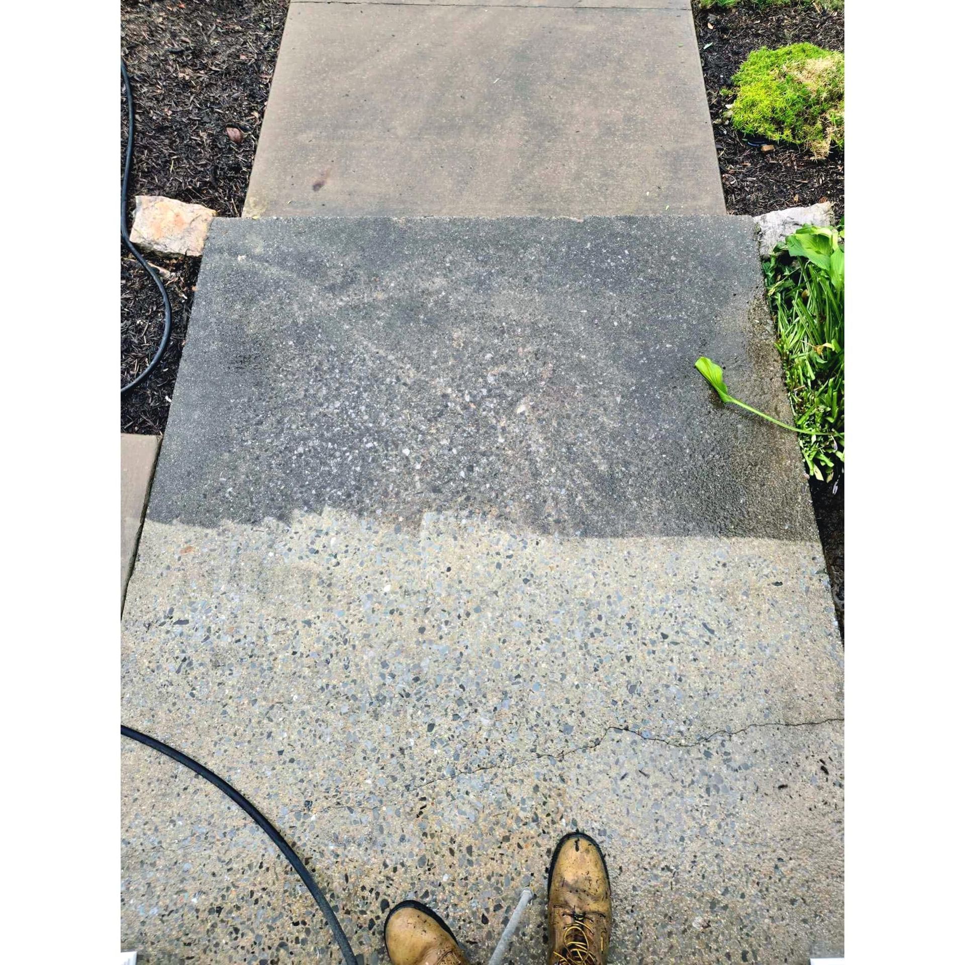 Concrete steps being pressure washed, showing clean vs. dirty sections.  Person's boots visible.