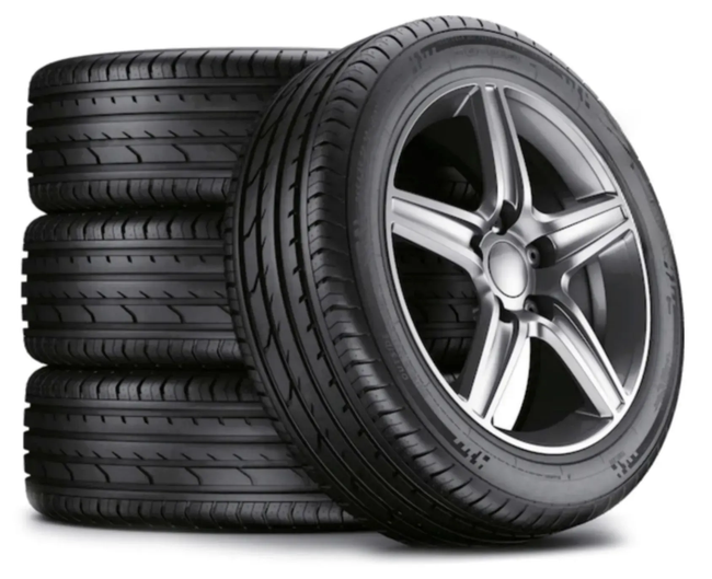 Set of four black car tires stacked with one mounted on a silver alloy wheel.