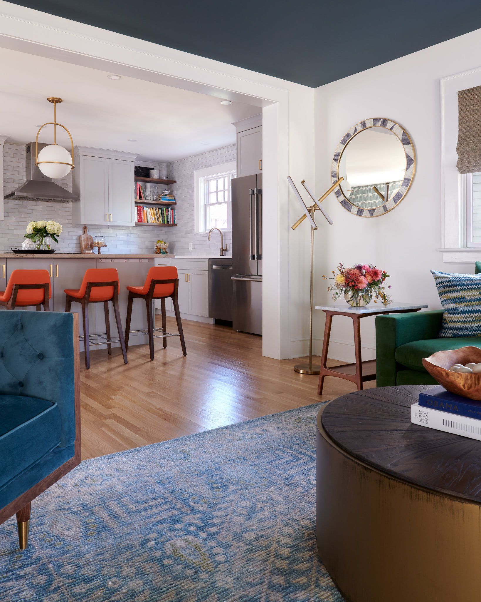 A living room with a blue ceiling and a green chair.