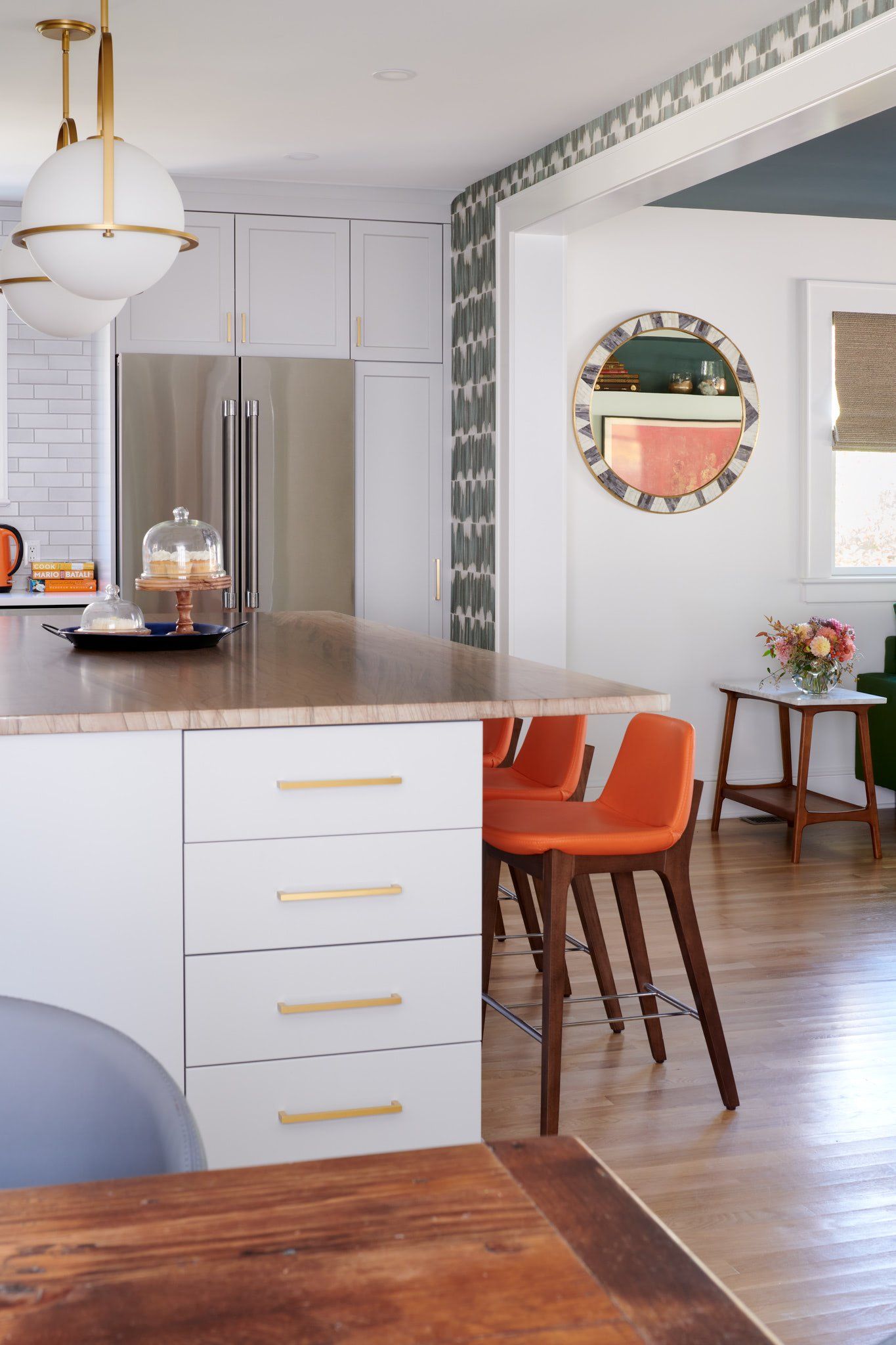 A kitchen with a table and chairs and a refrigerator