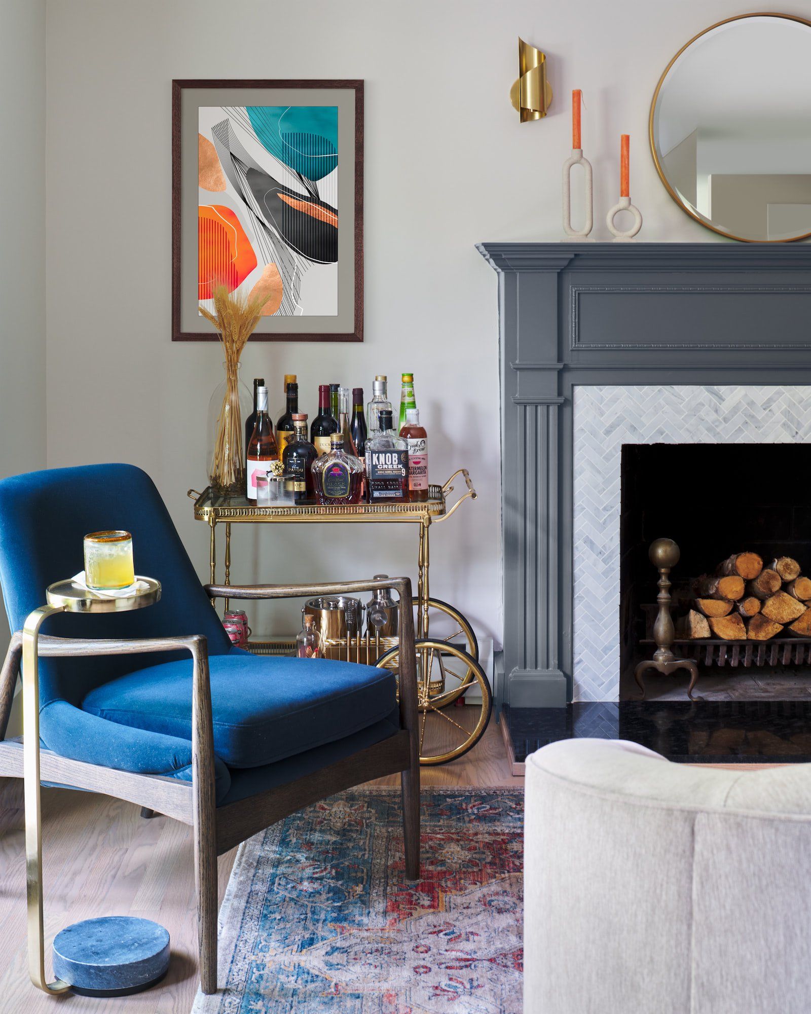 A living room with a fireplace and a bar cart