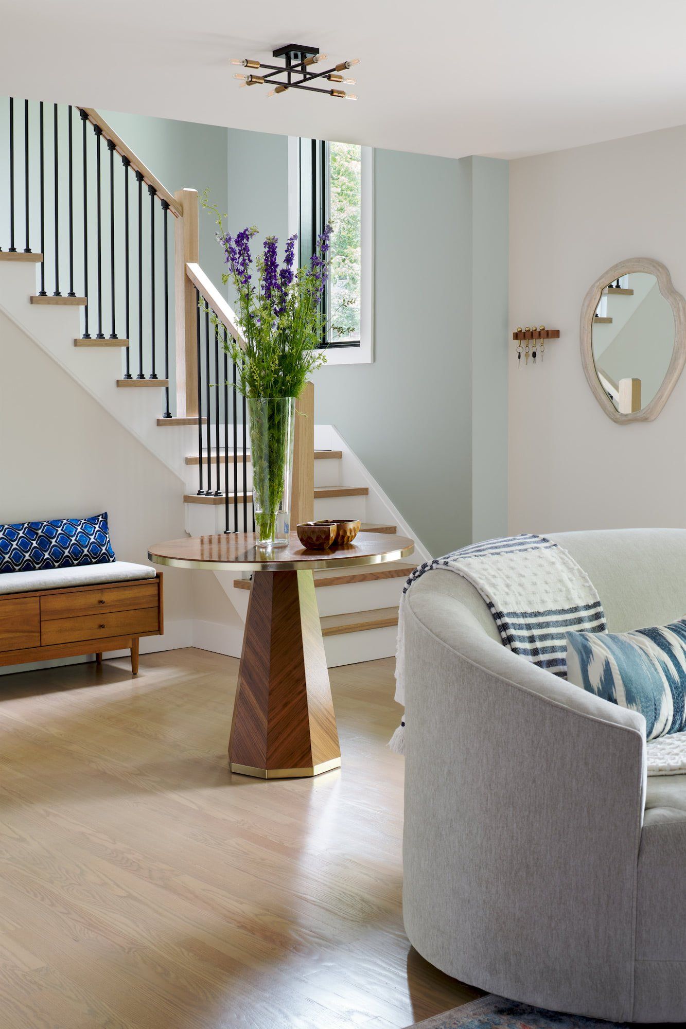 A living room with a couch and stairs in the background