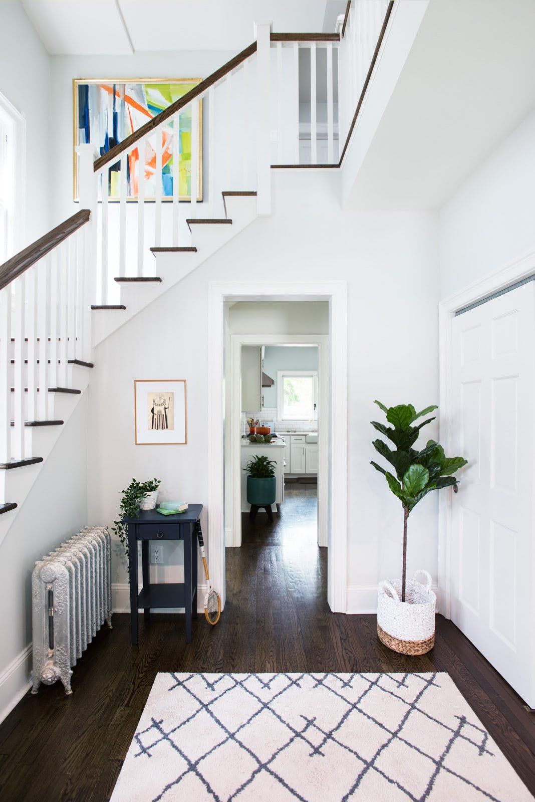 A hallway with stairs leading up to the second floor