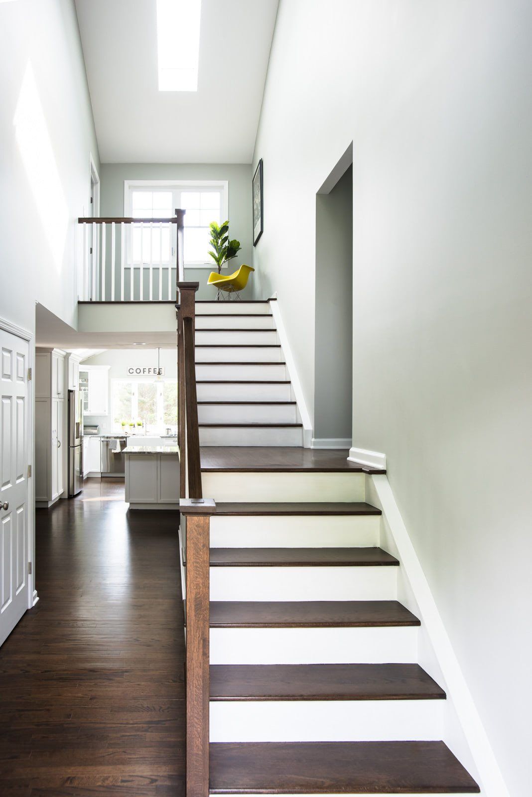 A hallway with stairs leading up to the second floor of a house.