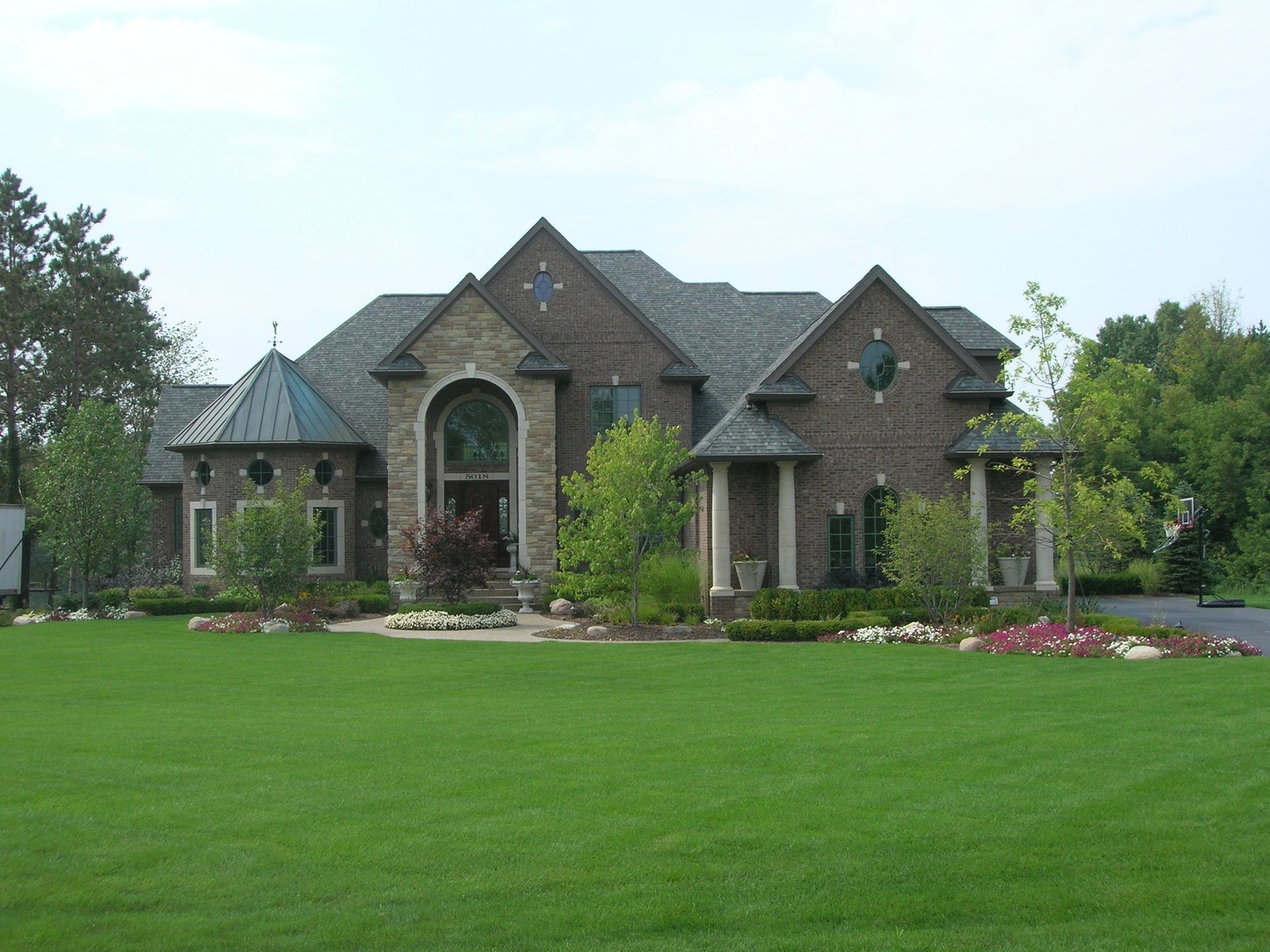 A large house with a lush green lawn in front of it