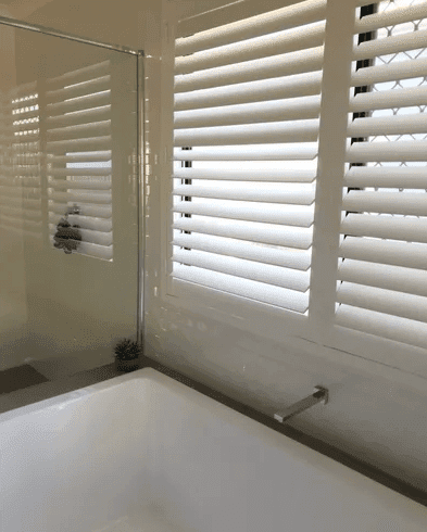 white PVC shutters installed in Brisbane bathroom by Advantage Screens & Blinds