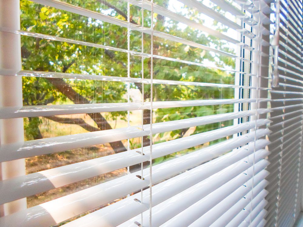 window with white pvc venetian blinds