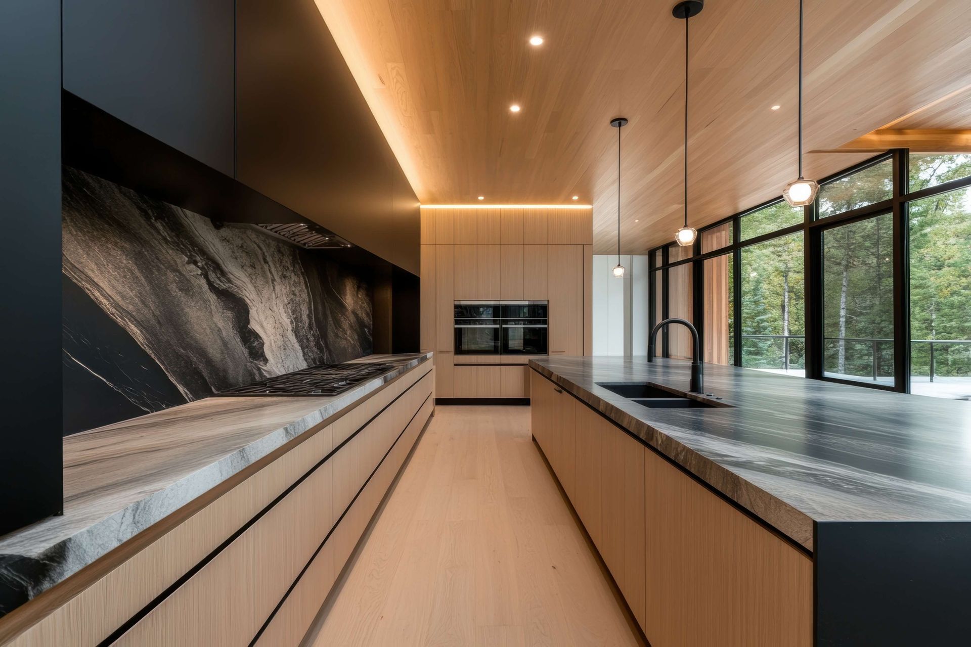 A kitchen with a stove , sink , and large windows.
