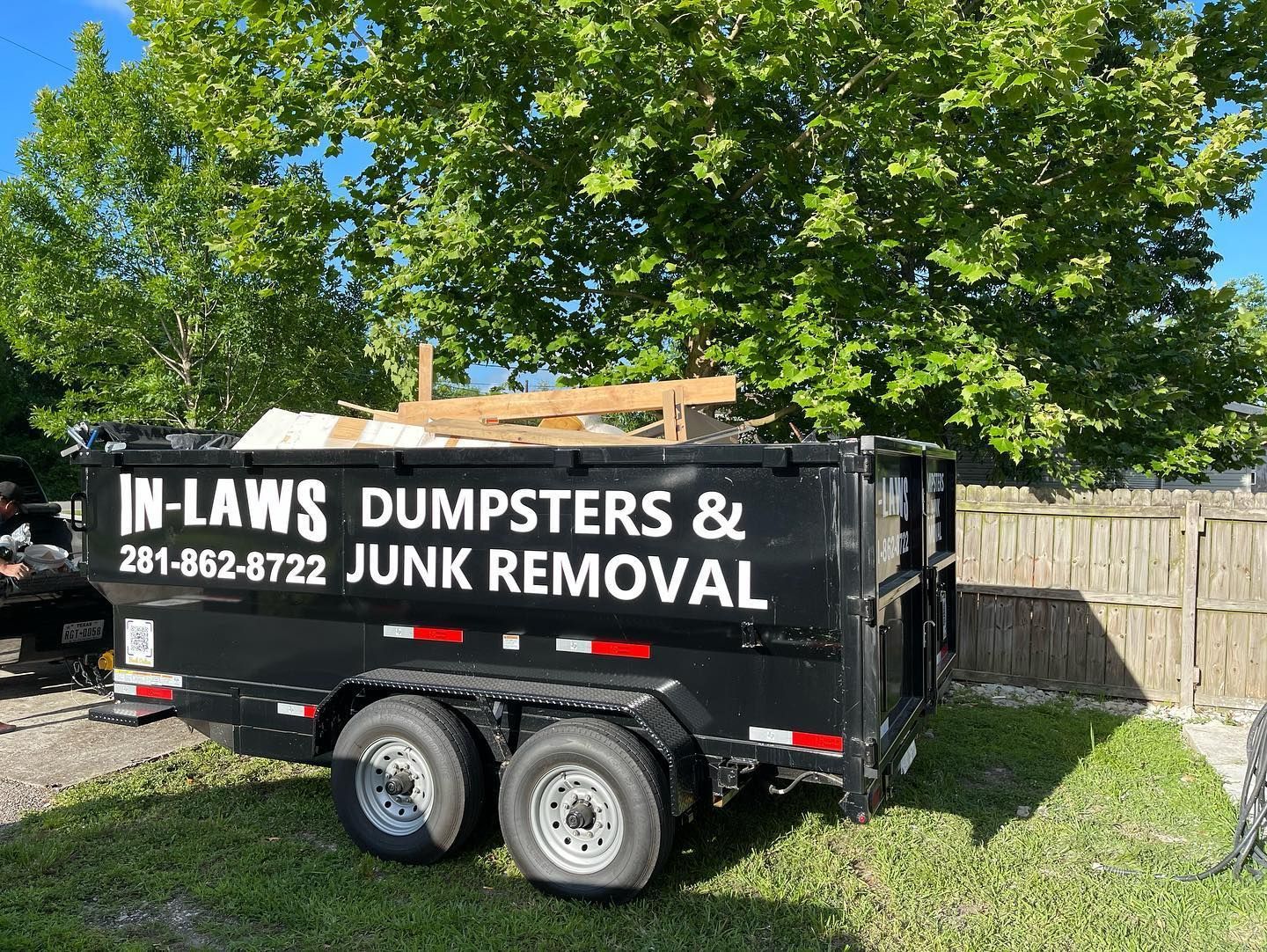 A photo of a 10 yard dumpster rental in Houston, Texas, from In-Laws Services assisting in cleanup.