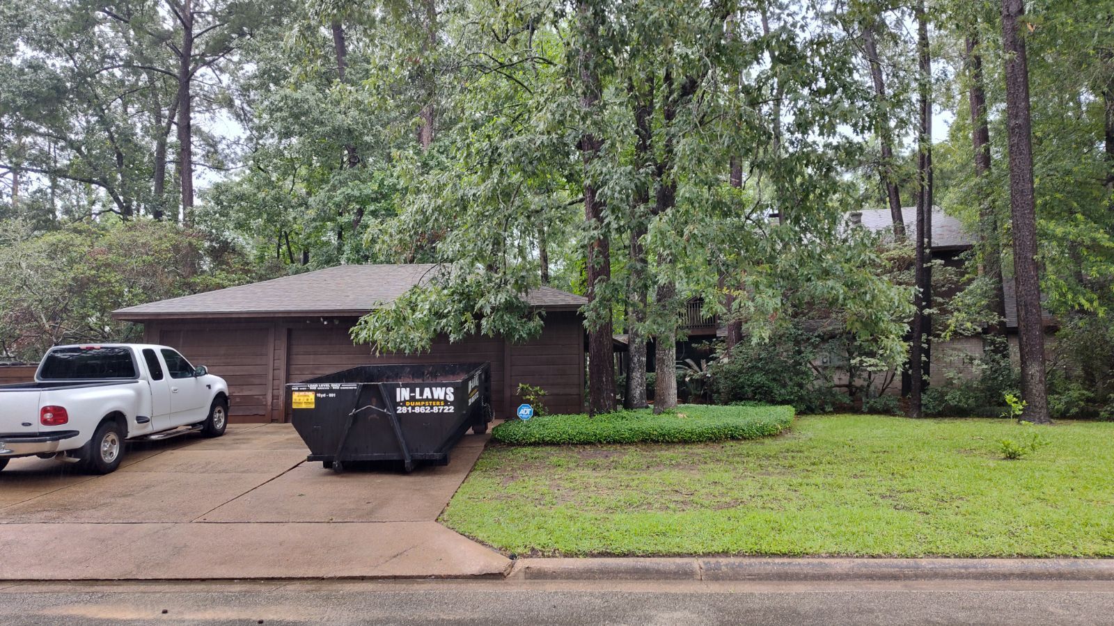 A photo of a 15 yard dumpster rental from In-Laws Services in Houston, TX, assisting in a cleanup.