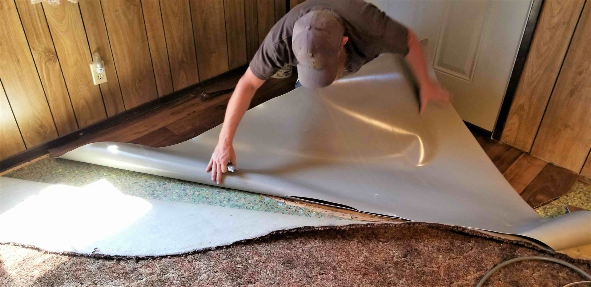 A photo of a man completing a carpet removal project for the first time.