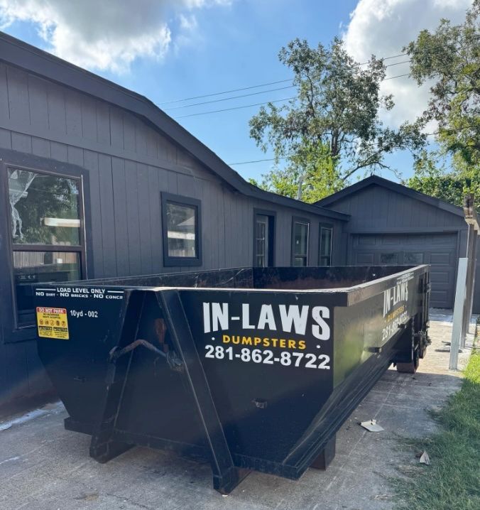 A photo of a dumpster rental at a home project site.