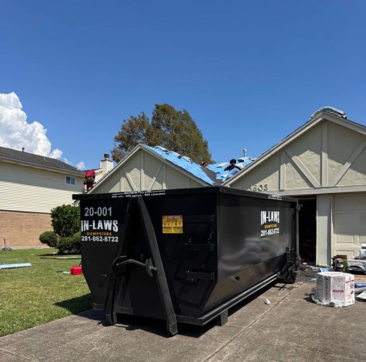 A photo of a dumpster rental that is being used by roof and siding contractors.
