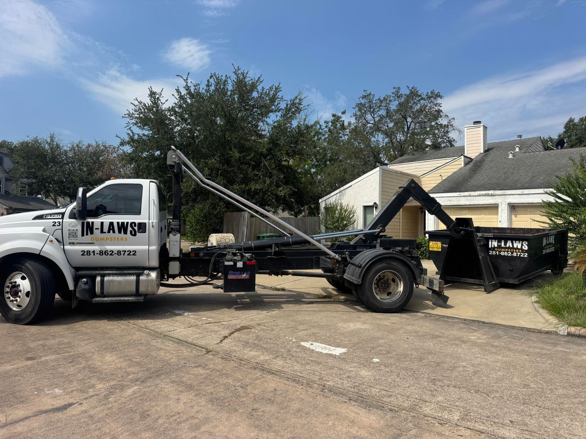 A photo of a dumpster rental being dropped off for estate cleanouts in Texas.