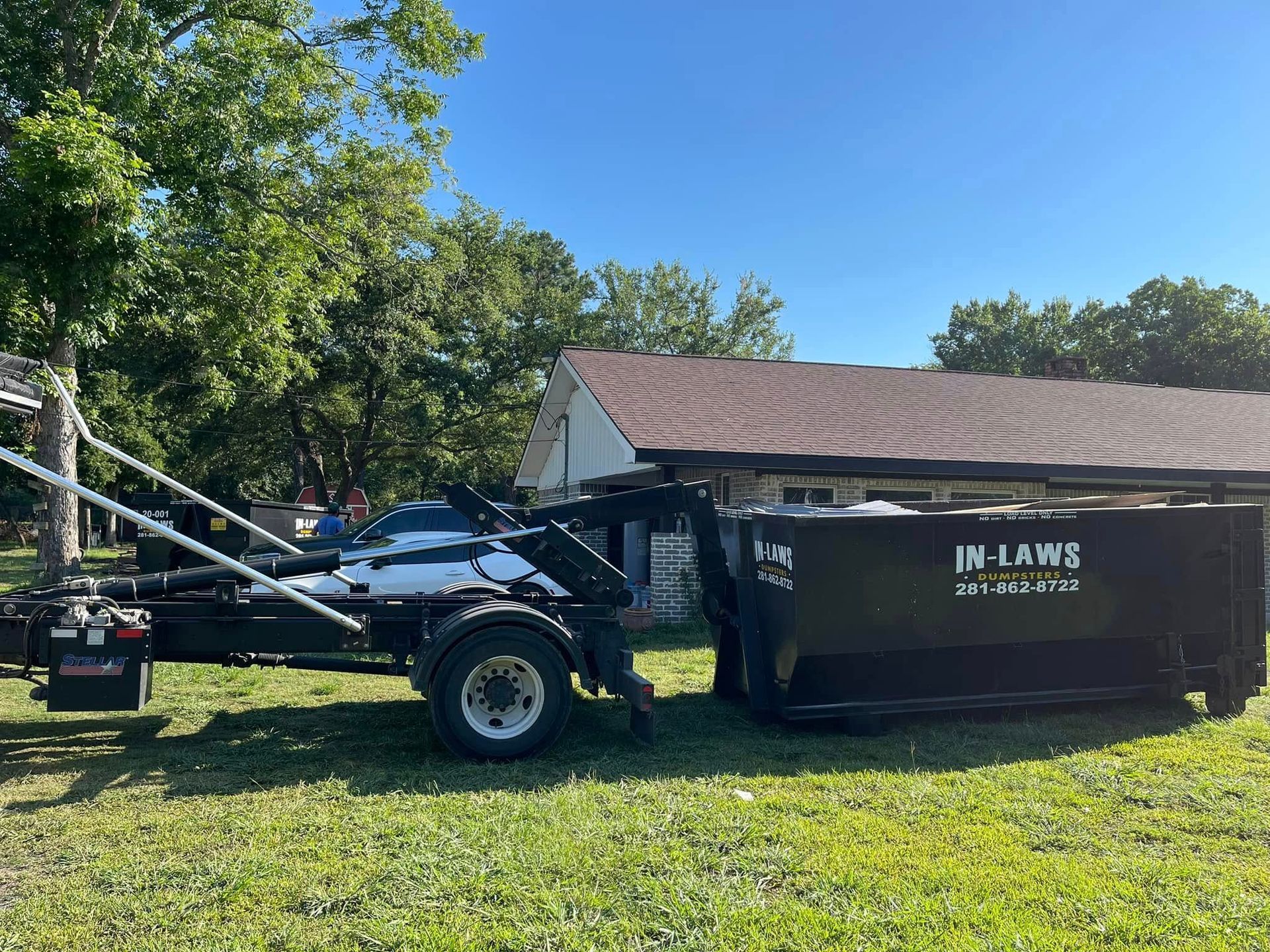 A photo of dumpster delivery to a home in East Houston, Texas, from In-Laws Services.