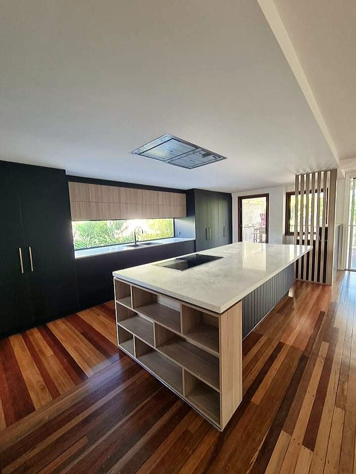 There is a large island in the middle of the kitchen.