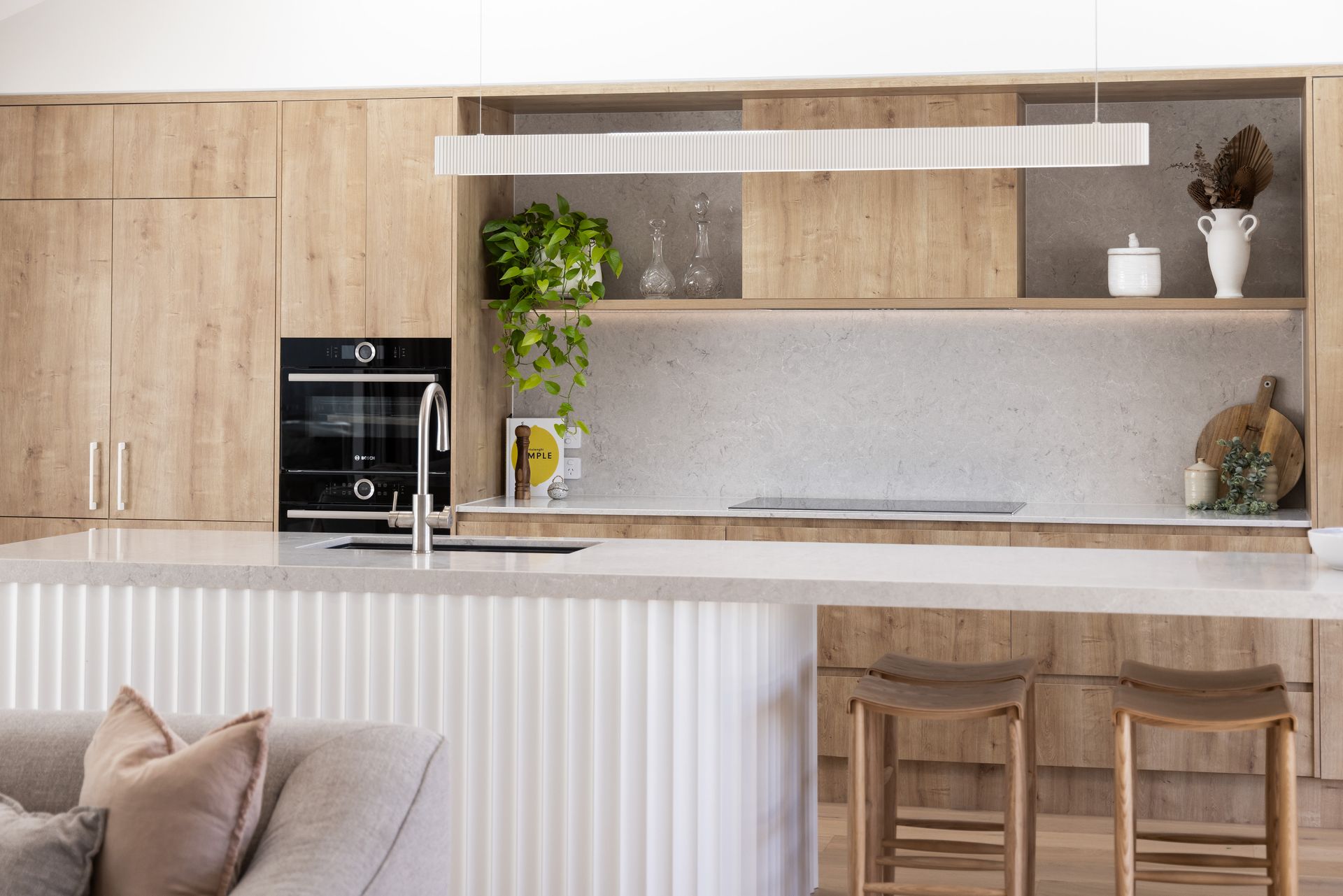 A Kitchen with A Long Island and Stools in It — Tailored Interiors in Coorparoo, QLD