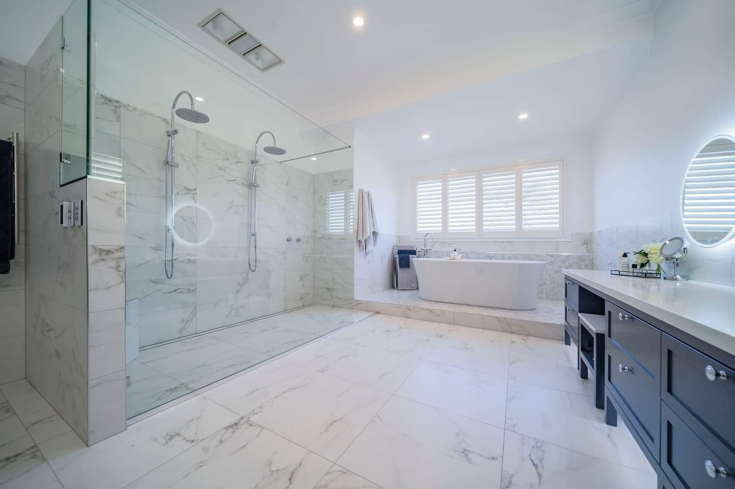 A bathroom with a walk in shower and a bathtub.