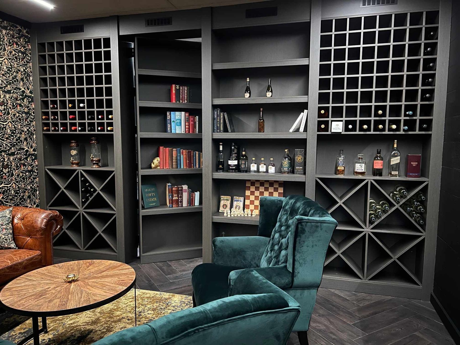 A Seating Room With Custom Wine Rack And Shelving Door — Tailored Interiors in Wacol, QLD