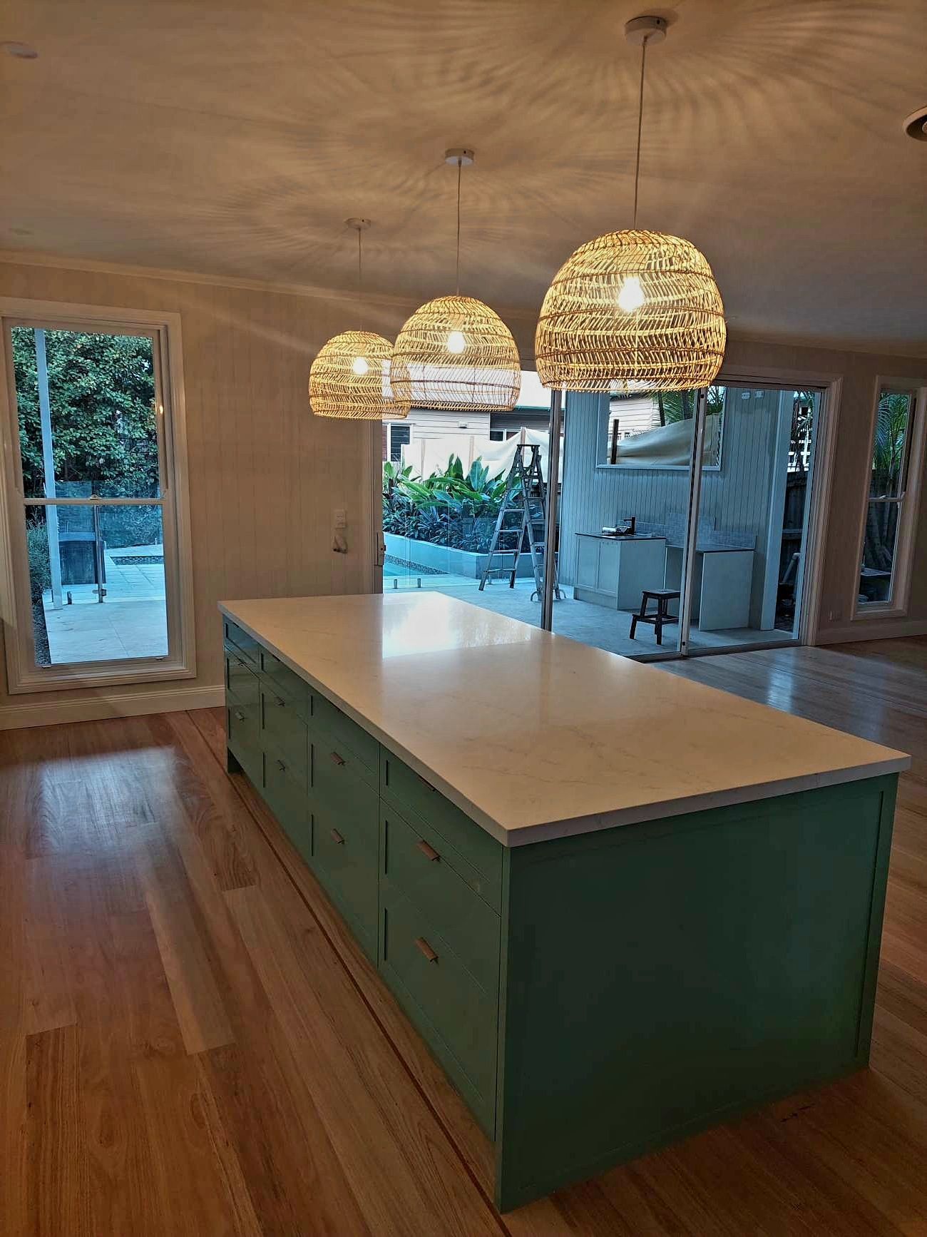 A kitchen with a large island and lots of windows