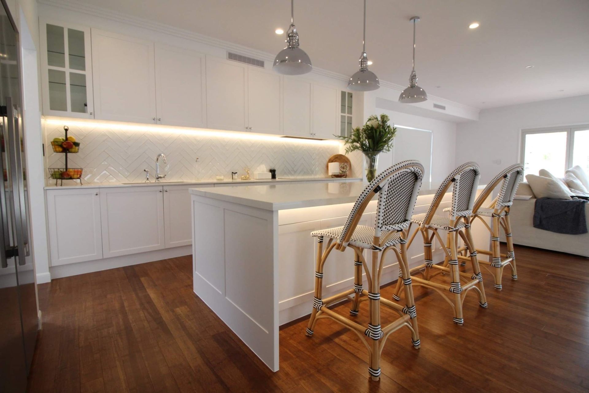 A Kitchen with White Cabinets and Pendant Lighting — Tailored Interiors in Wacol, QLD