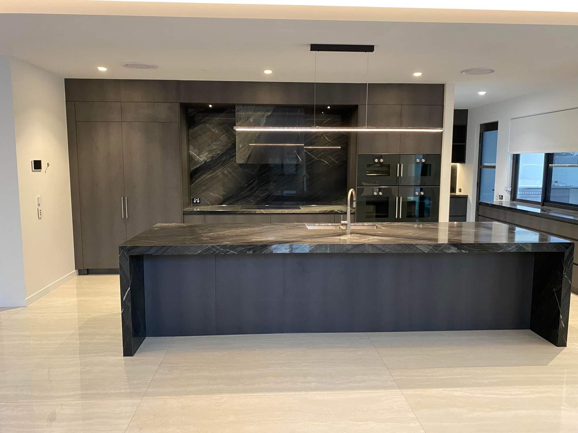 A Kitchen with A Marble Counter Top and A Sink — Tailored Interiors in Bulimba, QLD