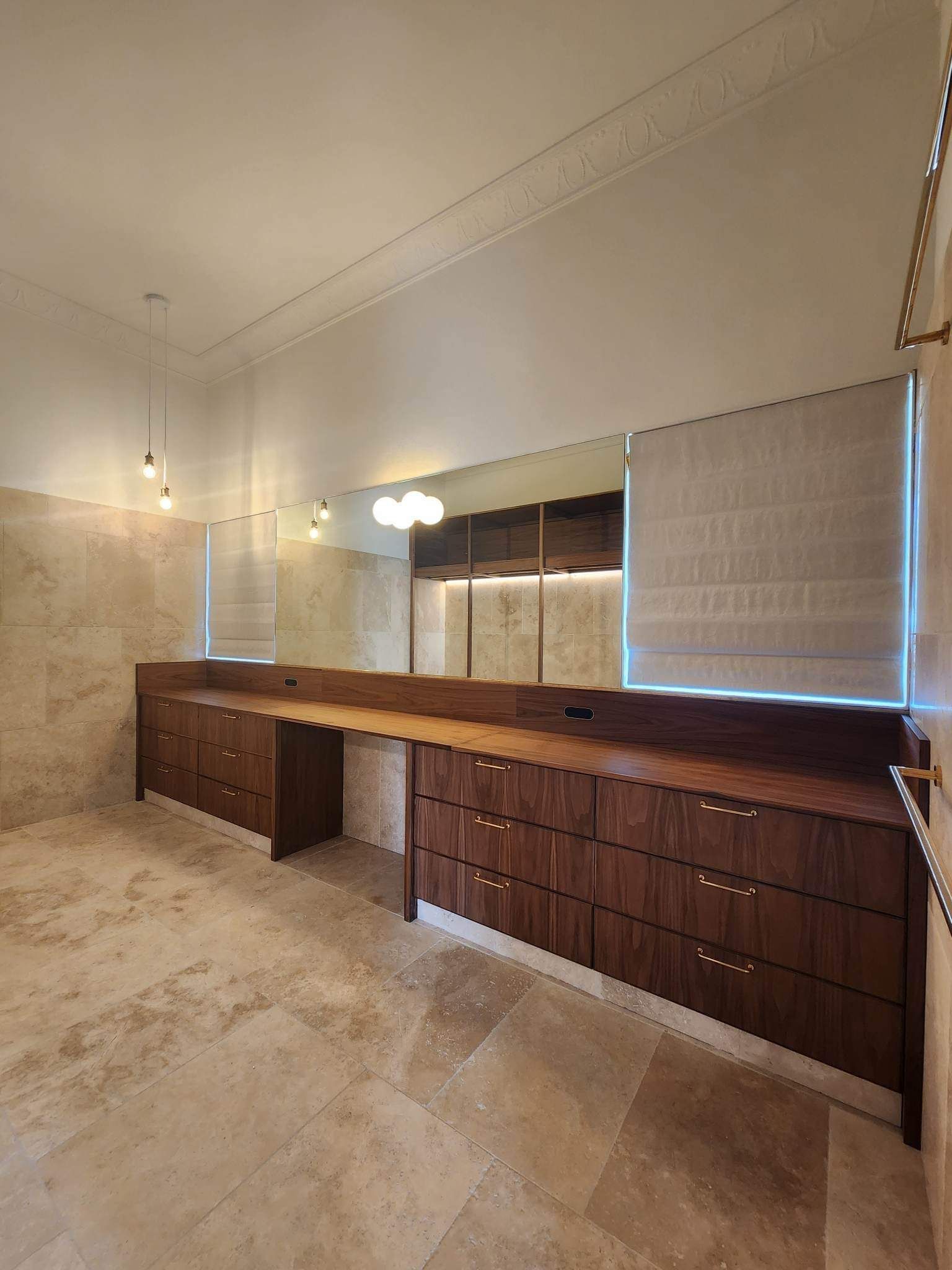 A Modern Kitchen with White Cabinets and Wooden Stools — Tailored Interiors in Capalaba, QLD