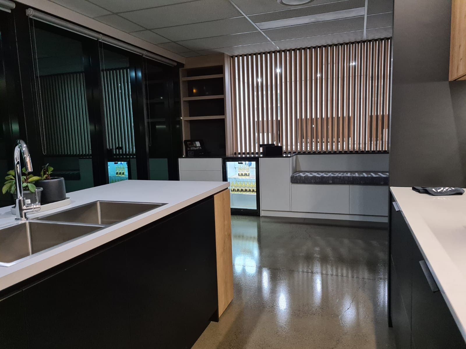 A kitchen with a sink and a refrigerator in it