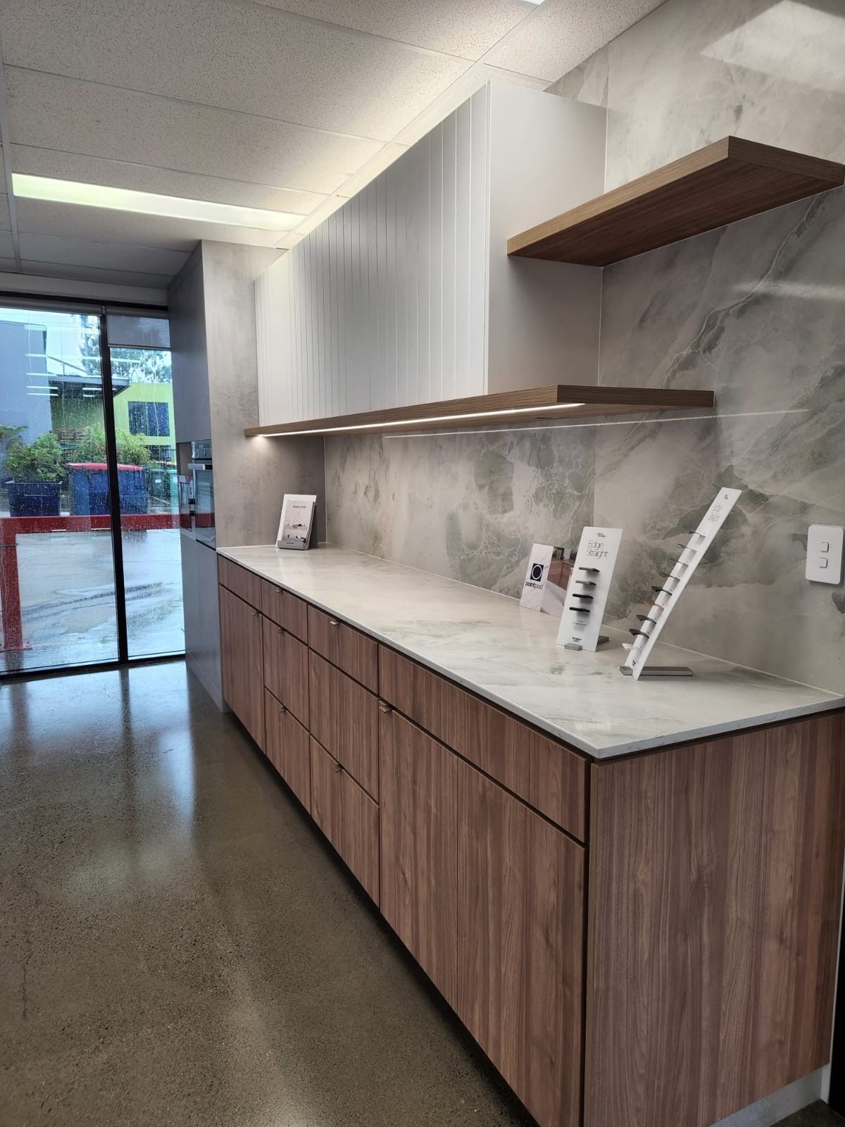 A Person Is Framing a Drawing of A Kitchen with Their Hands — Tailored Interiors in Wacol, QLD